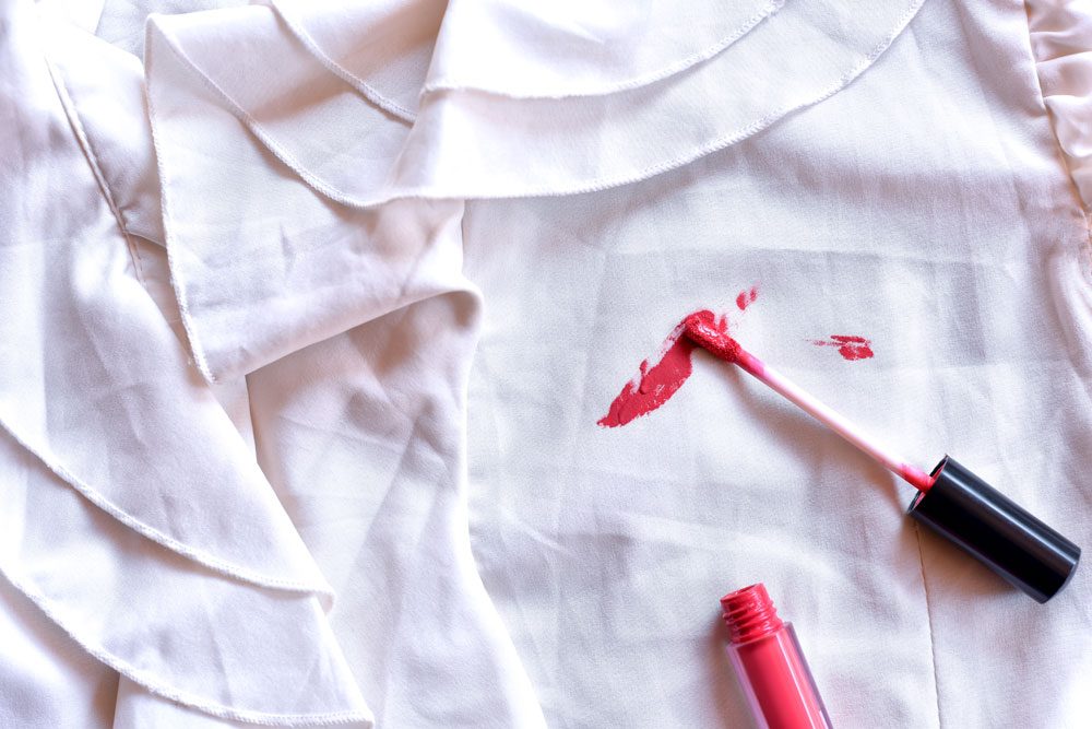 Lippenstift auf weißem Stoff Lippenstift Fleck auf der Kleidung