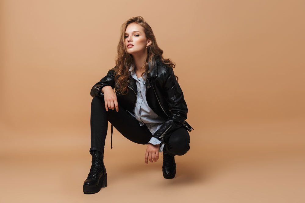 Junge Frau in schwarzer Skinny Jeans und Lederjacke Skinny Jeans und Lederjacke
